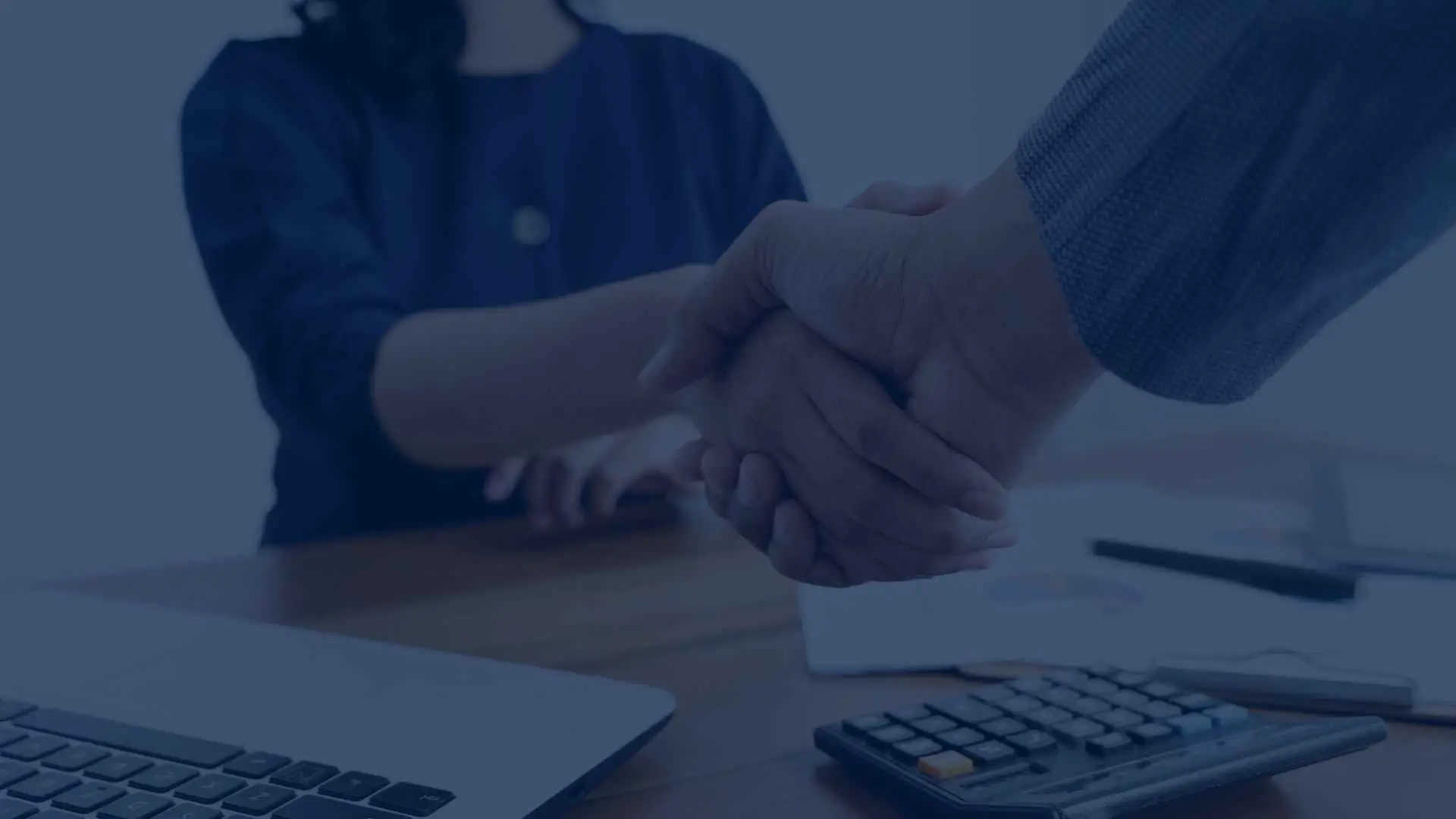 Close-up of a handshake between two business professionals, symbolizing a successful agreement or partnership.