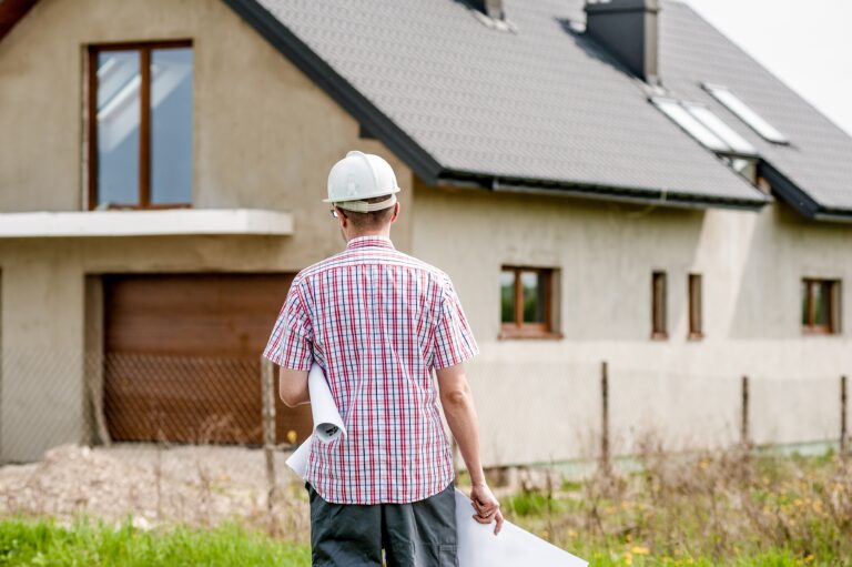 Man looking at house construction